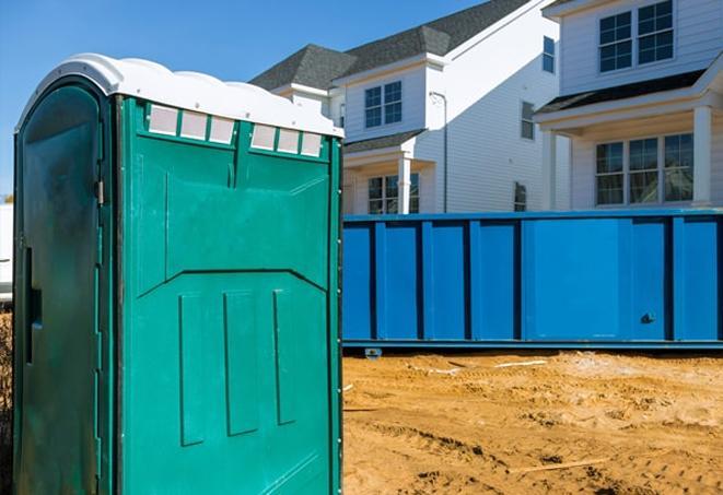 a row of porta potties located at a busy construction site